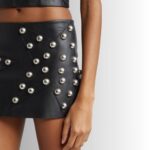Close-up of studded details on leather skirt