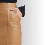 Close-up of tan leather skirt