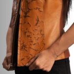 "Close-up of tan leather vest womens"