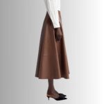 Side view of a chic chocolate brown leather skirt.